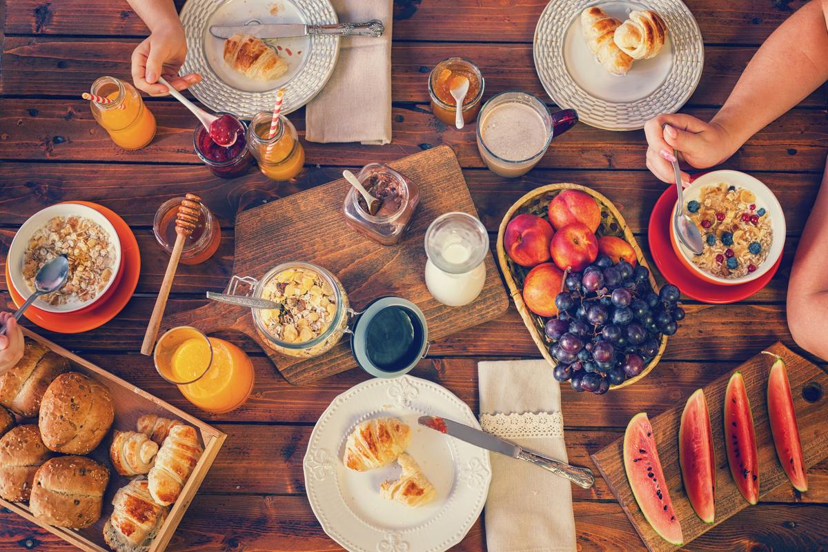 Young Happy Family Having Breakfast